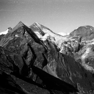 Majestic snow-capped mountain peaks in rugged terrain.