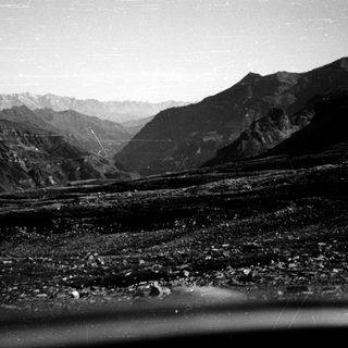 Mountainous landscape with rocky river valley.