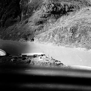 Dam and rocky mountainous reservoir.