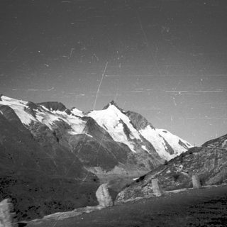 Majestic mountain range under starry night sky.