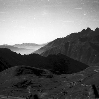 Starry night over rugged mountain landscape.