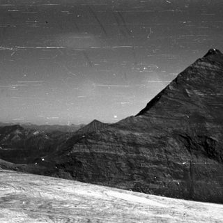 Pyramid silhouette against starry night sky.