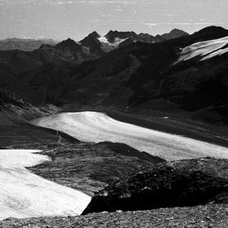 Glacier in mountainous alpine terrain.