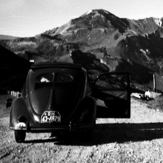 Classic car on mountain road.