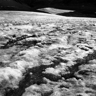 Lunar surface with rugged, cratered highlands.