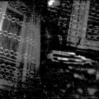 Blurred nighttime view of train tracks and passing train.