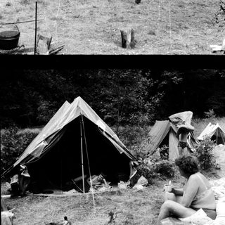 Campsite with tents and people outdoors.