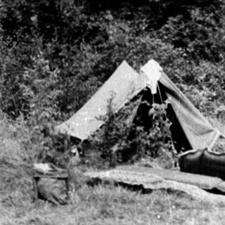 People engaged in outdoor survival or camping training.