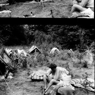 Campsite with tents and people relaxing outdoors.