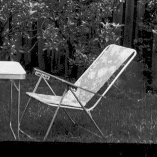 "Destructed garden scene with overturned furniture and debris."