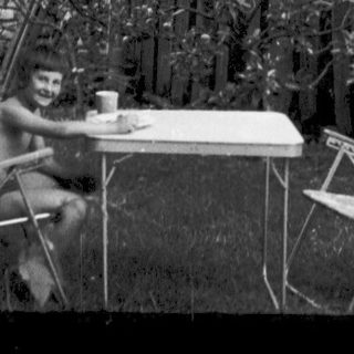 "Destructed garden scene with overturned furniture and debris."