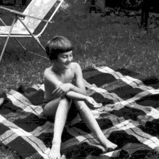Two children lounging on makeshift sunbathing platforms.