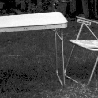 Two children lounging on makeshift sunbathing platforms.