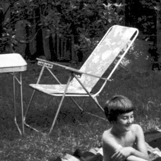 Two children lounging on makeshift sunbathing platforms.