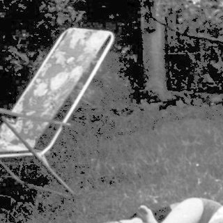 Blurred nighttime courtyard with person lying on blanket.