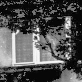 Blurred nighttime courtyard with person lying on blanket.
