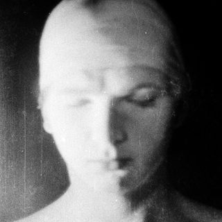 Blurred black-and-white portrait of a person.