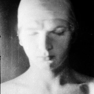 Blurred black-and-white portrait of a person.