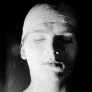 "Black-and-white statue of a sleeping or resting head."