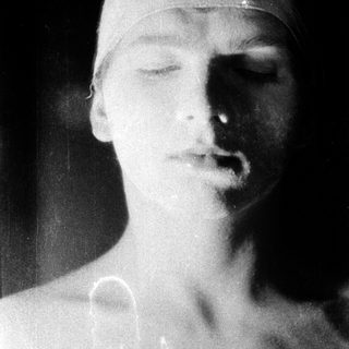 "Black-and-white statue of a sleeping or resting head."