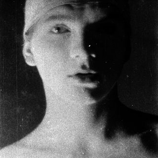 Black-and-white portrait of a young person in profile.