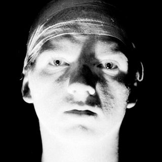 Close-up portrait of person with bandaged head.