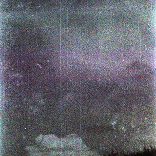 Dark night sky with faint stars and faint horizon glow.