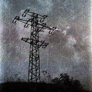 High-voltage power transmission tower with lines.