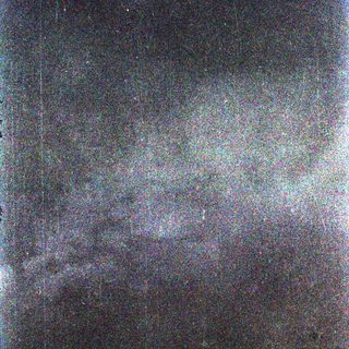 Dark night sky with faint, blurred celestial light.
