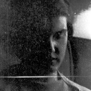 Blurred black-and-white portrait of a person.