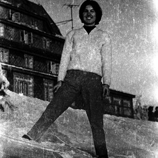 Young man posing outdoors in snowy setting.