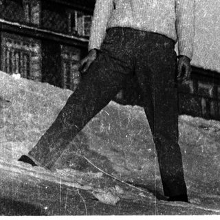 Young man posing outdoors in snowy setting.