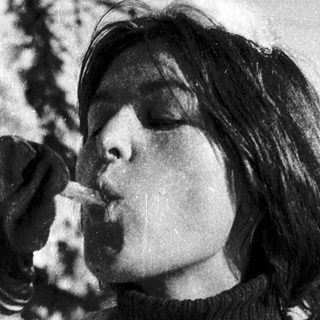 Person eating snow in winter outdoors.