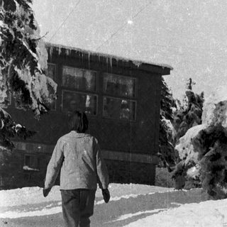 Person walking in snow-covered outdoor area.