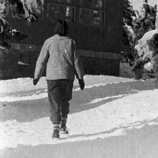 Person walking in snow-covered outdoor area.