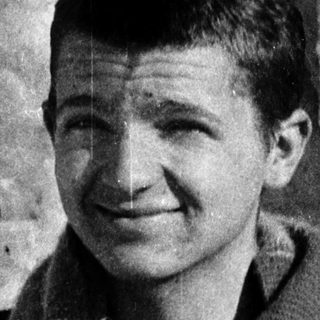 Young man smiling outdoors in cold weather.