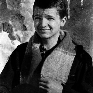 Young man smiling outdoors in cold weather.