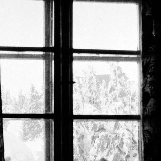 Frost-covered window panes at night.