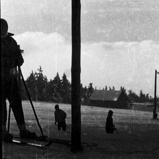 Photographer taking vintage landscape photo with subjects.