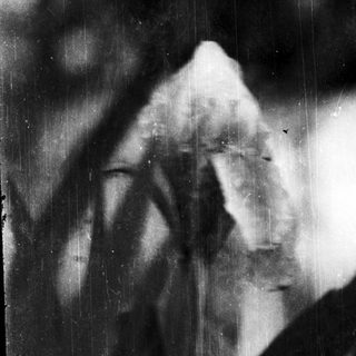 Blurred silhouette of person with hands over face.