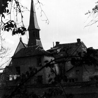 Historic stone building with pointed church steeple.
