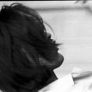 Back view of person with short, dark hair.