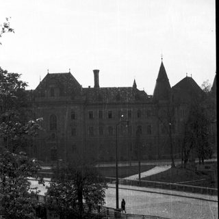 Historic building with spires near waterfront park.