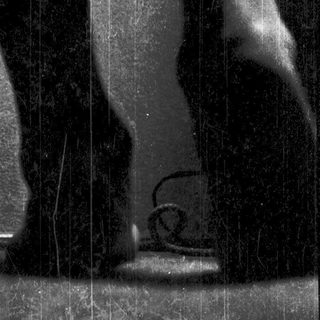 Statue depicting dynamic human legs in motion.