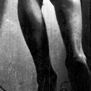 Statue depicting dynamic human legs in motion.