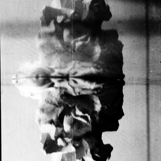 A person's shadow and reflection in water.