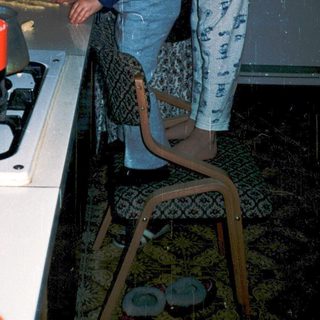 Woman cooking pancakes on gas stove.