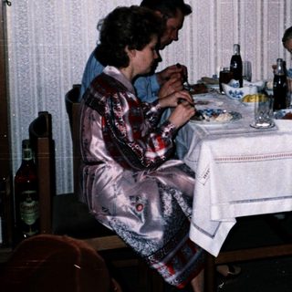 Family dining together indoors at night.