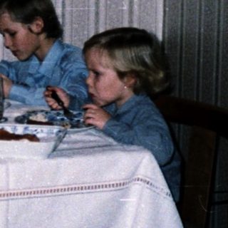 Family dining together indoors at night.