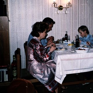 Family dining together indoors at night.